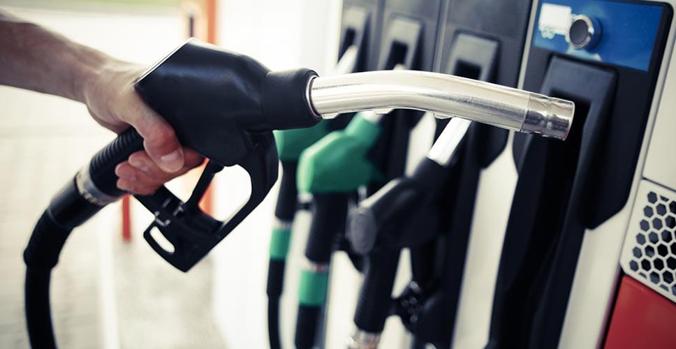 A driver fills up his moving truck with gas.