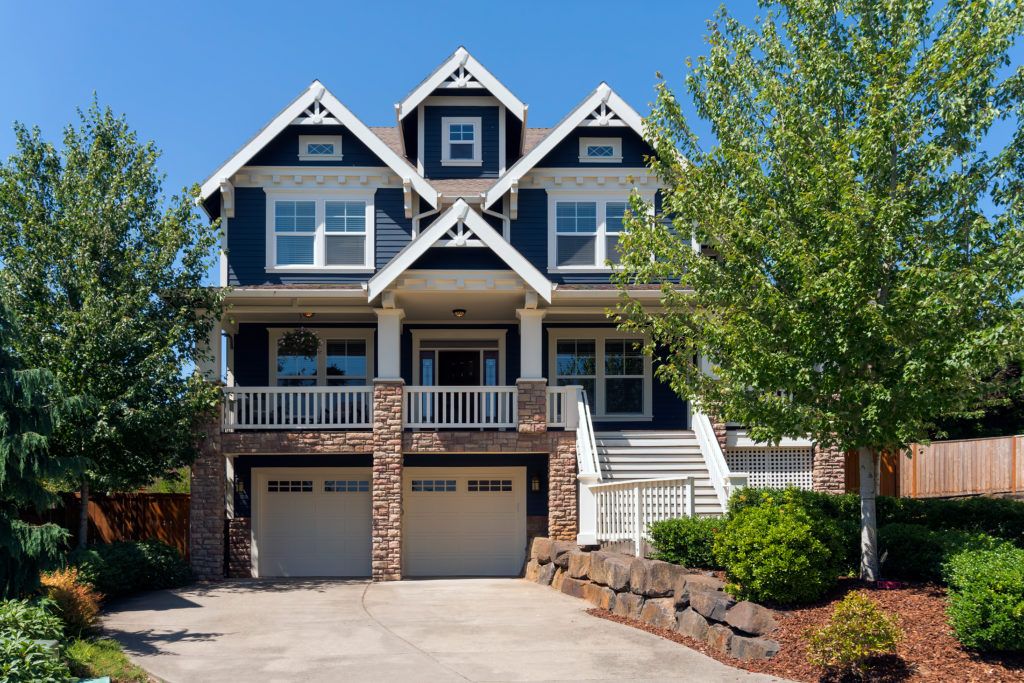 Two story victorian style home with beautiful front yard landscape