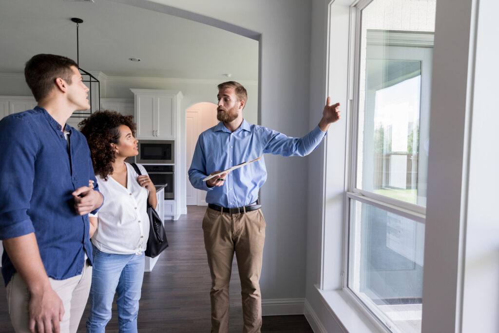 Male home inspector shows new homeowners repairs that need to be made