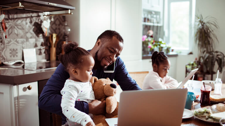 Young Family using a Laptop during Breakfast