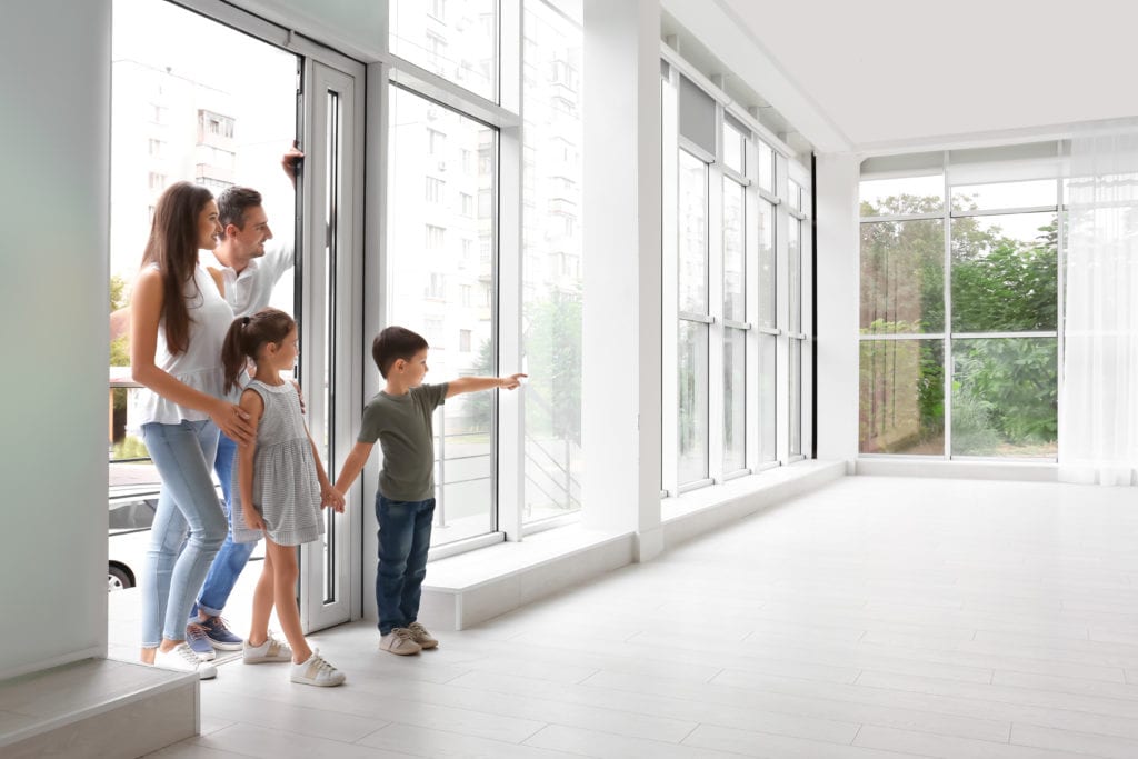 Family walking into new empty house