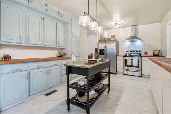 Traditional style kitchen with marble floors and rolling island