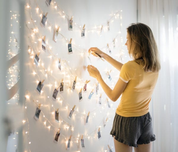 Girl creating a photo wall